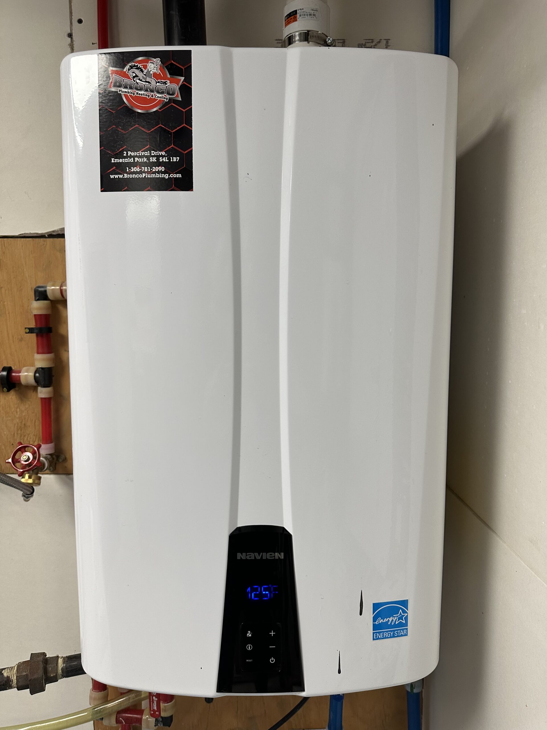 Woman hands setting temperature of water in heater electric boiler. Interior details close-up